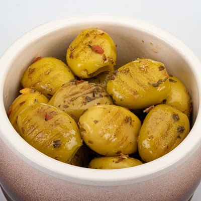Grilled organic green olives marinated - stock pack